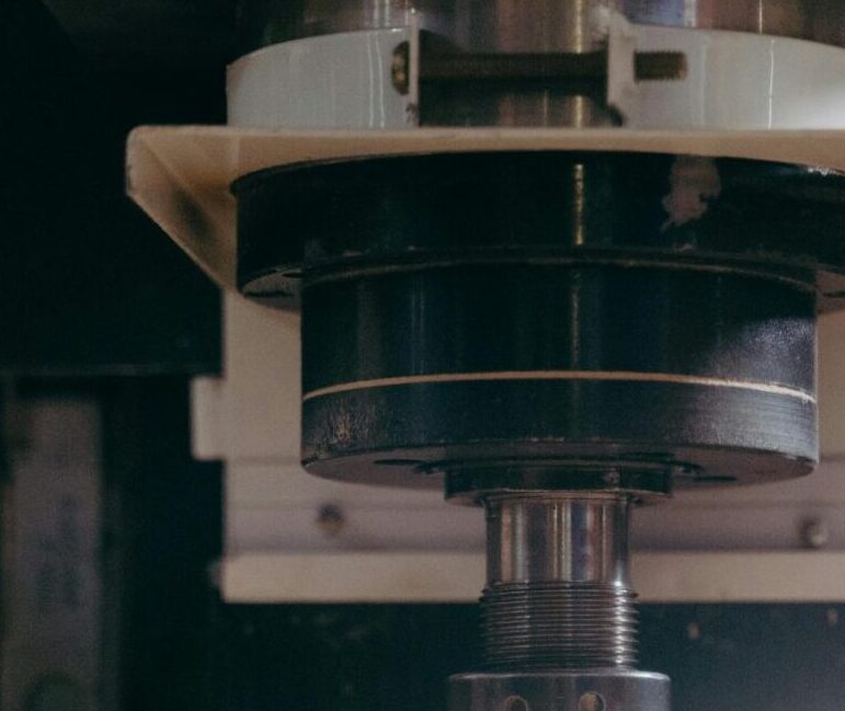 Detailed view of a CNC machine carving material, showcasing industrial precision.